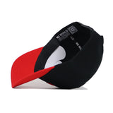 A black and red Nebraska Tailgate Hat by No Rivals is shown upside down, revealing its interior with a NO RIVALS label and QR code in the sweatband, crafted from high-quality cotton for a structured fit.