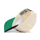 The South Alabama Ballpark Hat by No Rivals is shown upside down, featuring a cream color, green underbrim, blue inner rim, and a QR code label with "NO RIVALS" inside its high-quality cotton structured fit.