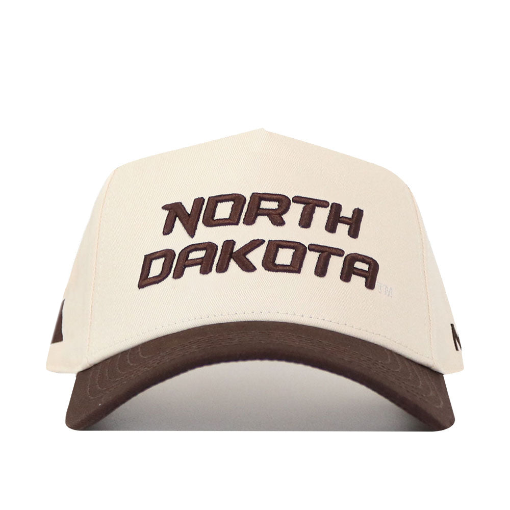The North Dakota Espresso Hat by No Rivals features "NORTH DAKOTA" in striking brown lettering across the front, complemented by an embroidered logo for extra detail. This beige cap is finished with a coordinating brown brim and includes a snap back closure for easy size adjustment.