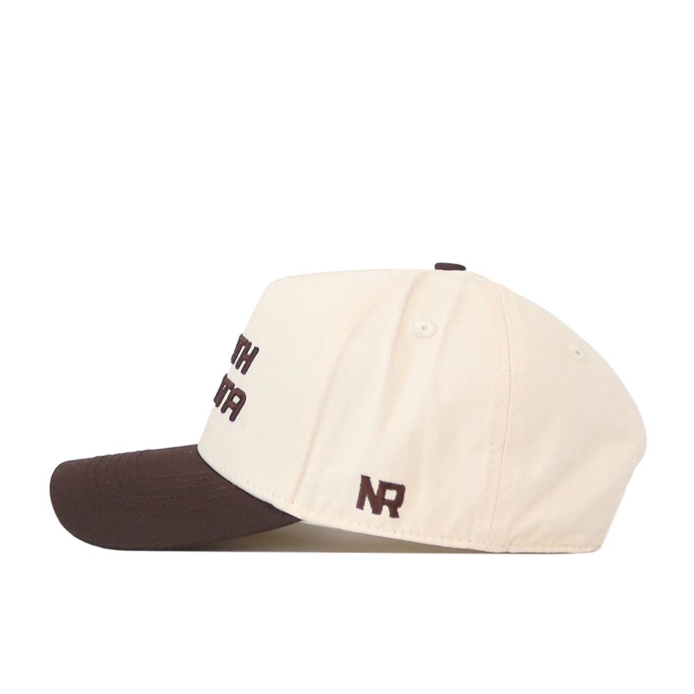 A side view of the No Rivals North Dakota Espresso Hat, featuring a cream front panel and crown with a contrasting brown brim. The hat includes a dark brown, officially licensed embroidered "NR" logo on the side.
