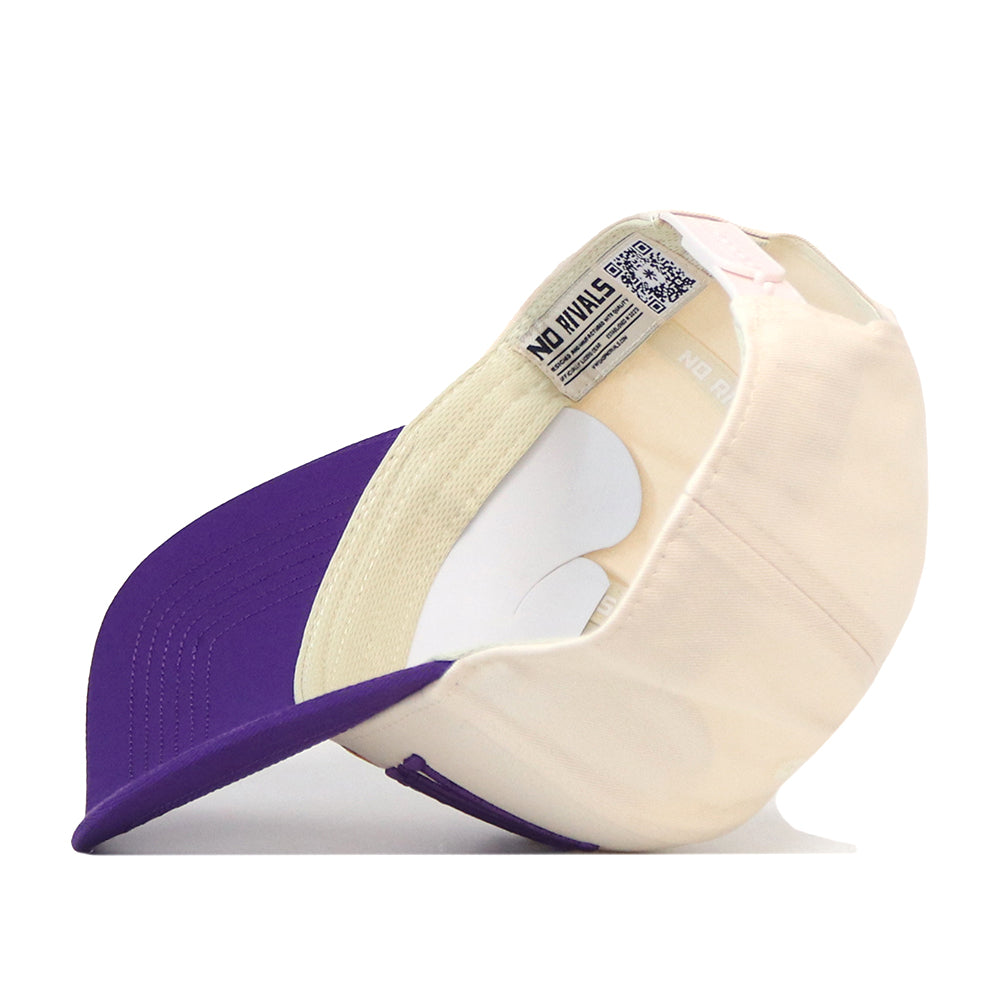 A cream-colored Minnesota State Mankato Mavericks Stride Hat by No Rivals is shown upside down, revealing the inside lining, sweatband, and labels—including one with a QR code and the text NO FINALS. This perfect Gameday Fit Snap Back features a purple brim and detailed embroidered logos for a stylish finish.