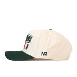 Side view of the Miami Hurricanes Stride Hat by No Rivals, a cream-colored baseball cap with a green brim, crafted from high-quality cotton. The front showcases embroidered text and logo, while the letters NR are stitched on the side. Designed with a structured fit for added durability.