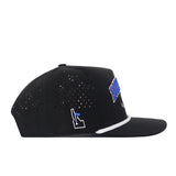 The No Rivals Boise State Golf Hat in black features ventilation holes, a white outline of Idaho, a blue side design, and white trim above the brim. This snap back cap displays an officially licensed embroidered logo and is shown in a side profile view against a white background.
