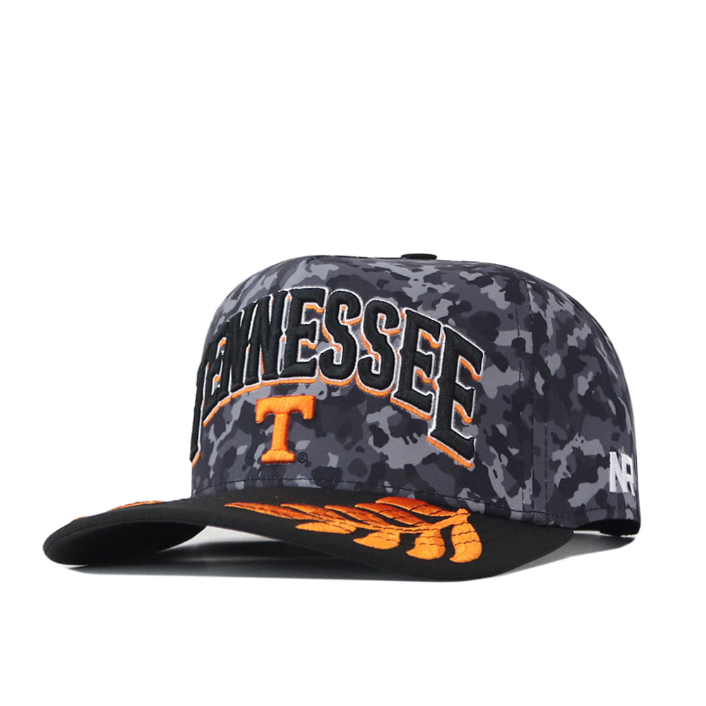 Show your Volunteer pride with the No Rivals Tennessee Volunteers 2026 Military Appreciation Hat. This officially licensed snapback features a bold black and gray camouflage design, “TENNESSEE” and a large orange T embroidered on the front, and vibrant orange wing-inspired accents on the brim. The side is detailed with AR stitching, making this hat a striking choice for any fan.