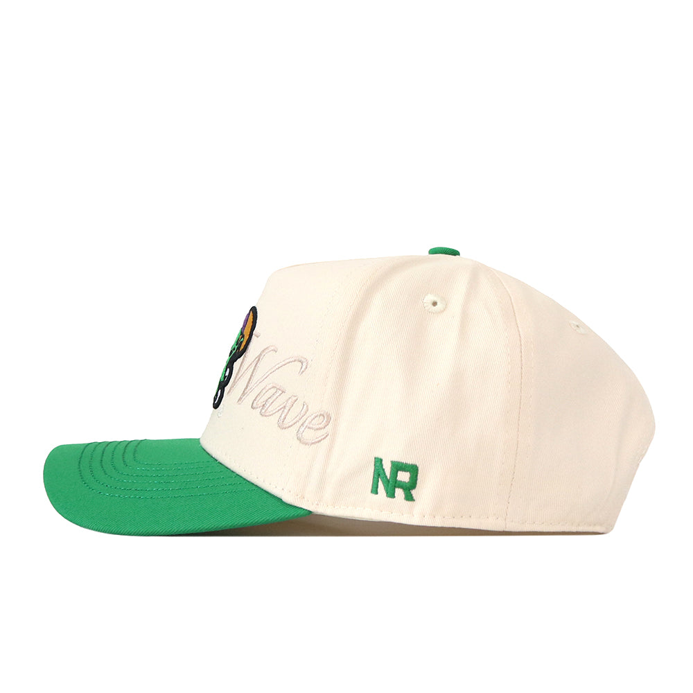 The Tulane Mardi Gras Roulez Wave Hat by No Rivals is a white cap with a green brim, showcasing an embroidered logo and detailed text designs on the front and side—pictured from a side angle, it’s the perfect finishing touch for your gameday fit.