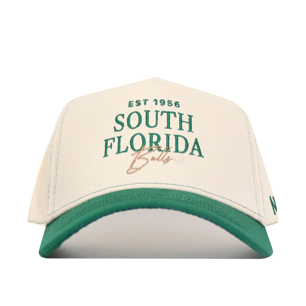 The No Rivals USF Vintage Hat is a white snapback with a green brim, made from premium cotton. Features "EST 1956 SOUTH FLORIDA Bulls" embroidered in green and tan. Officially licensed—perfect for true fans.