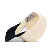 The No Rivals Wake Forest "The Couch" Walk-Off Hat is an adjustable beige and black cotton cap with a black bill, featuring a NO RIVALS label and QR code on the inner band.