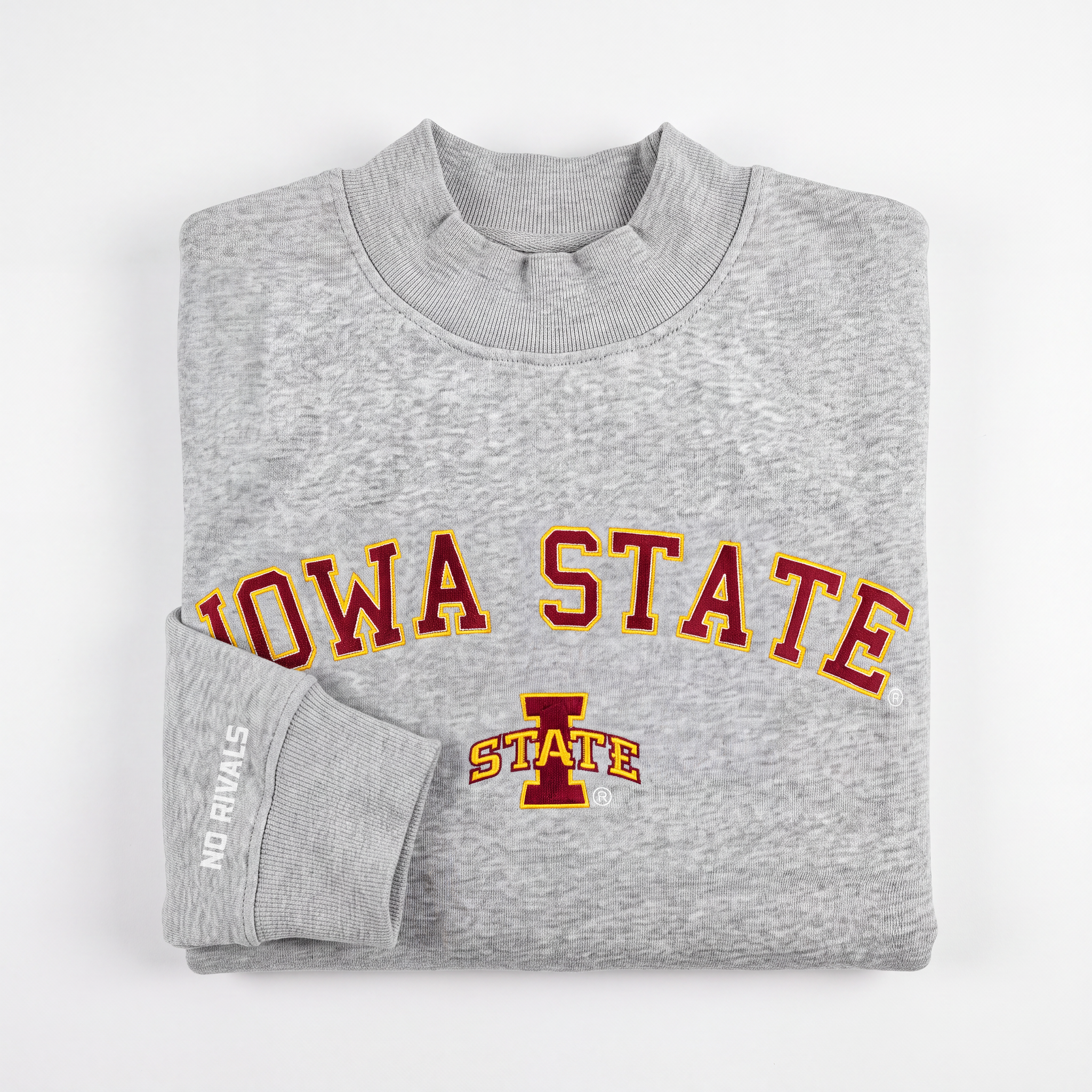 A folded Iowa State Gray Mock Neck sweatshirt by No Rivals, featuring "IOWA STATE" in red and yellow lettering with a front logo. Made from heavyweight cotton with a soft fleece lining, it offers an oversized fit for added comfort. The sleeve is detailed with "NO RIVALS" in white text.