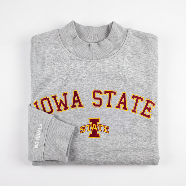 A folded Iowa State Gray Mock Neck sweatshirt by No Rivals, featuring "IOWA STATE" in red and yellow lettering with a front logo. Made from heavyweight cotton with a soft fleece lining, it offers an oversized fit for added comfort. The sleeve is detailed with "NO RIVALS" in white text.