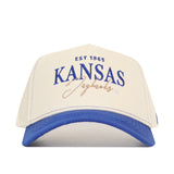 The No Rivals University of Kansas Vintage Hat is a cream and blue cotton baseball cap with "EST 1865 KANSAS Jayhawks" embroidered in blue and gold, adjustable snap back, and is officially licensed.
