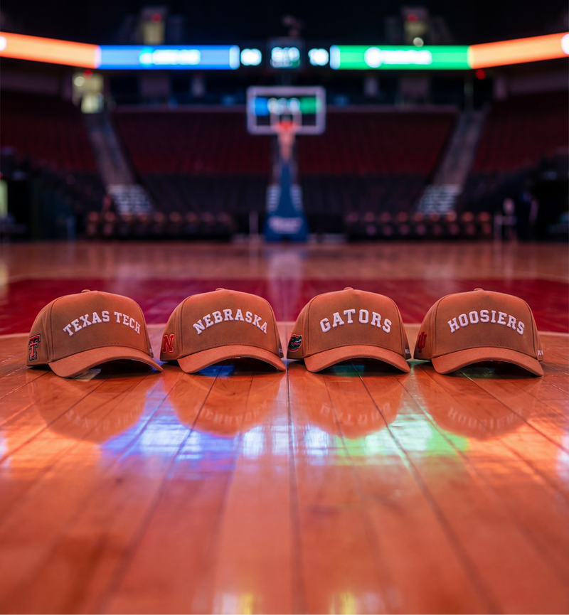 Four orange hats with different text on a basketball court