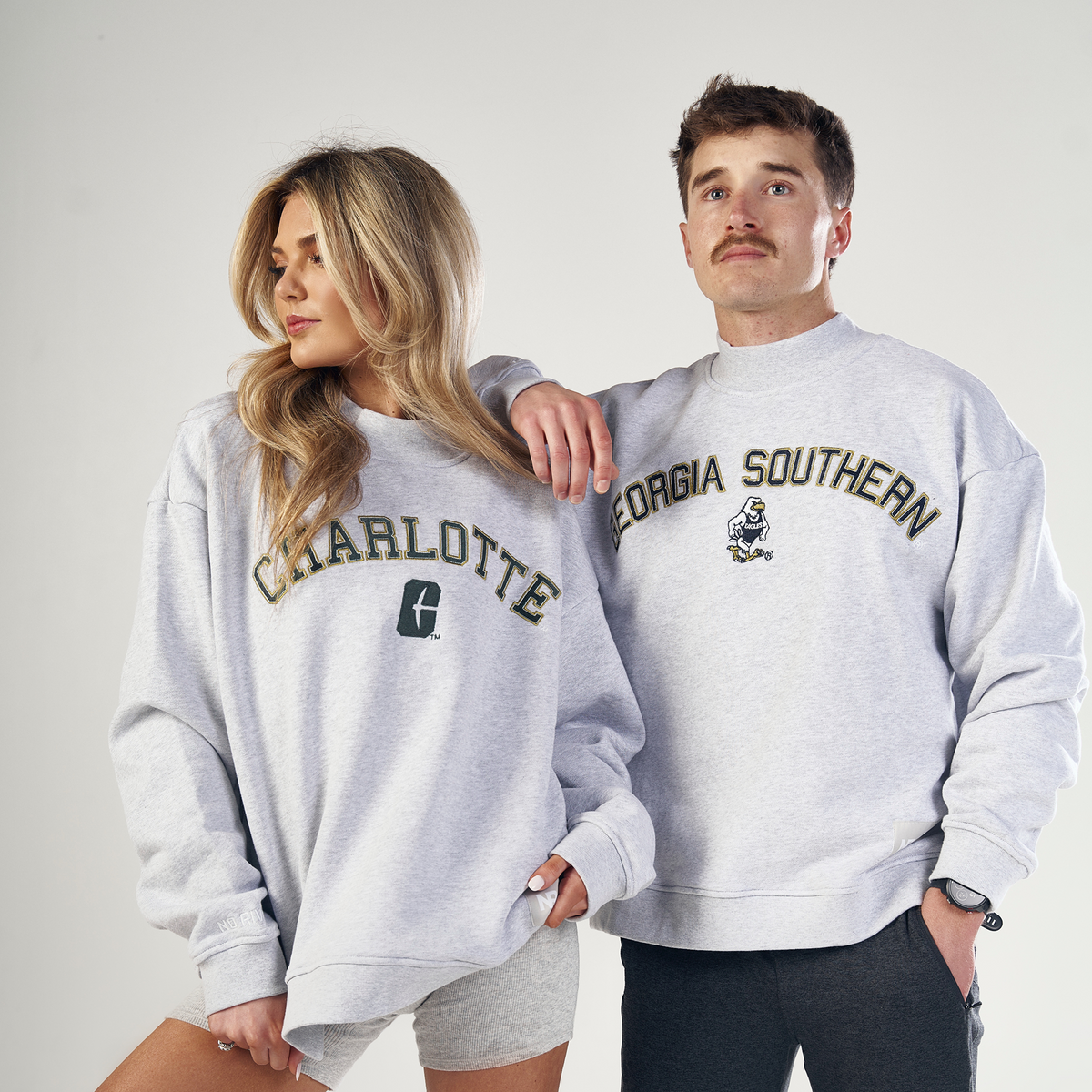 Two people stand side by side in oversized fit Vanderbilt Mock Neck sweatshirts by No Rivals, crafted from heavyweight cotton. Both look confidently away from the camera against a plain light background.