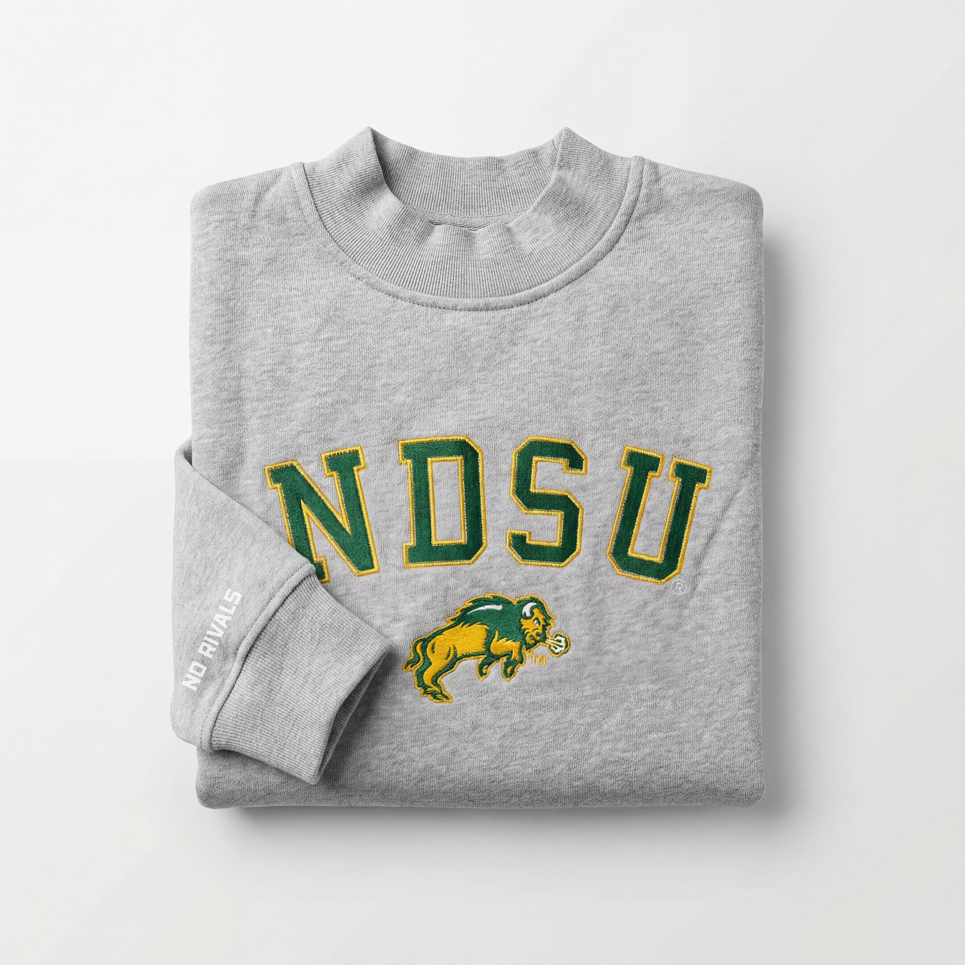 The NDSU Mock Neck by No Rivals is a folded gray heavyweight cotton sweatshirt featuring "NDSU" in green and yellow with a bison logo on the front, and "NO RIVALS" printed in white on one sleeve.