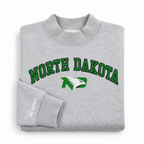 Folded, oversized gray North Dakota Mock Neck sweatshirt with a mock neck and a North Dakota hawk logo printed on the chest.