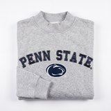 A folded Penn State Mock Neck sweatshirt by No Rivals, featuring PENN STATE and the Nittany Lion logo printed in navy blue and white on the front, crafted from heavyweight cotton with a soft fleece interior, displayed on a white background.