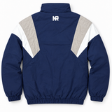 The Penn State Hockey Retro Windbreaker - Navy by No Rivals features white and beige chevron panels on the sleeves, a small white NR logo below the back collar, and elastic cuffs and hem.