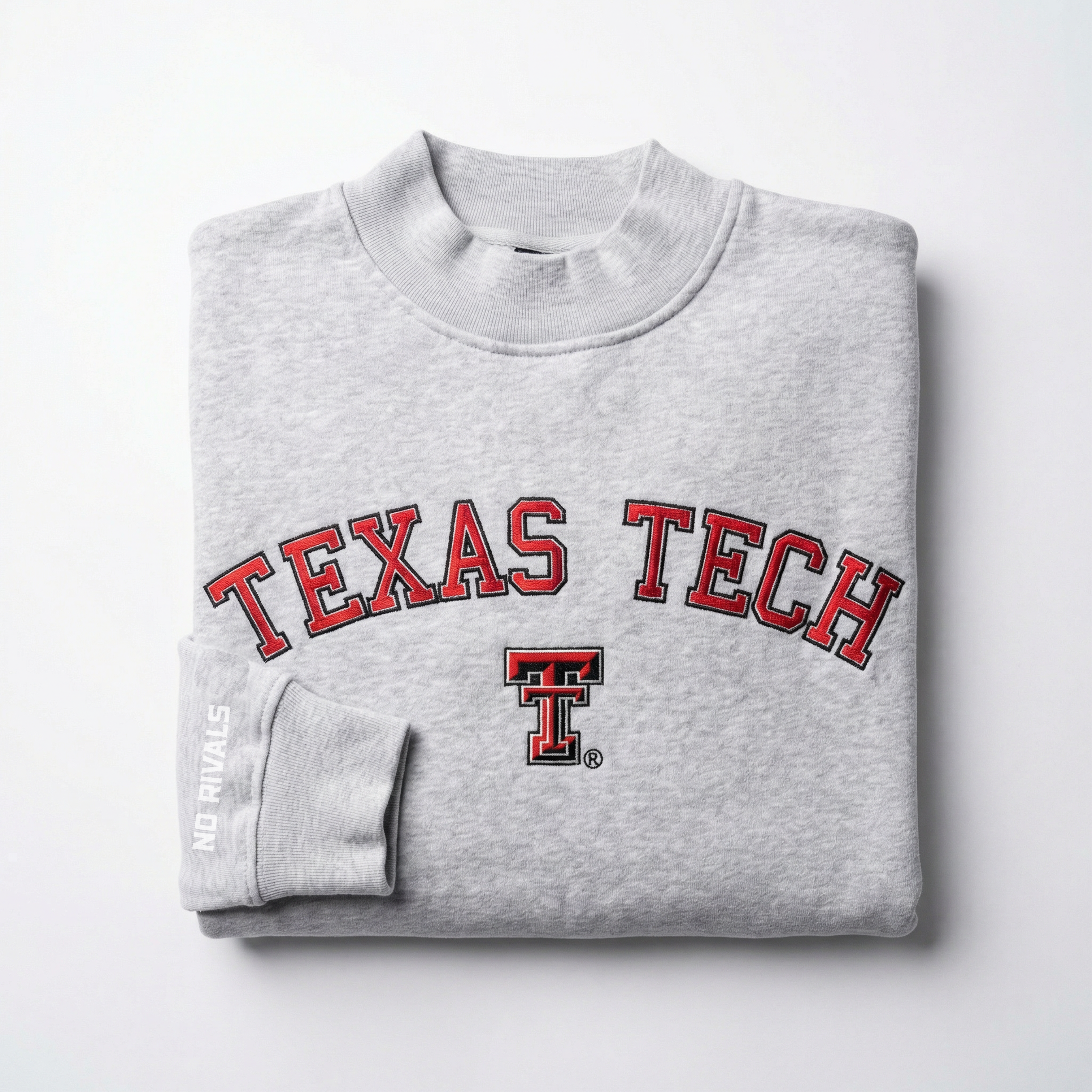 A folded gray heavyweight Texas Tech Mock Neck by No Rivals, featuring “TEXAS TECH” in red and black with a central double-T logo, and “NO RIVALS” printed on the sleeve.