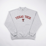 A light gray heavyweight cotton mock neck sweatshirt by No Rivals featuring "Texas Tech" in red and black across the chest with the double T logo underneath, shown laid flat on a white background.
