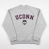 A gray UConn Mock Neck sweatshirt by No Rivals, crafted from heavyweight cotton and designed with an oversized fit for ultimate comfort. The front showcases "UCONN" in bold navy and red letters, with a husky dog logo displayed beneath the text.