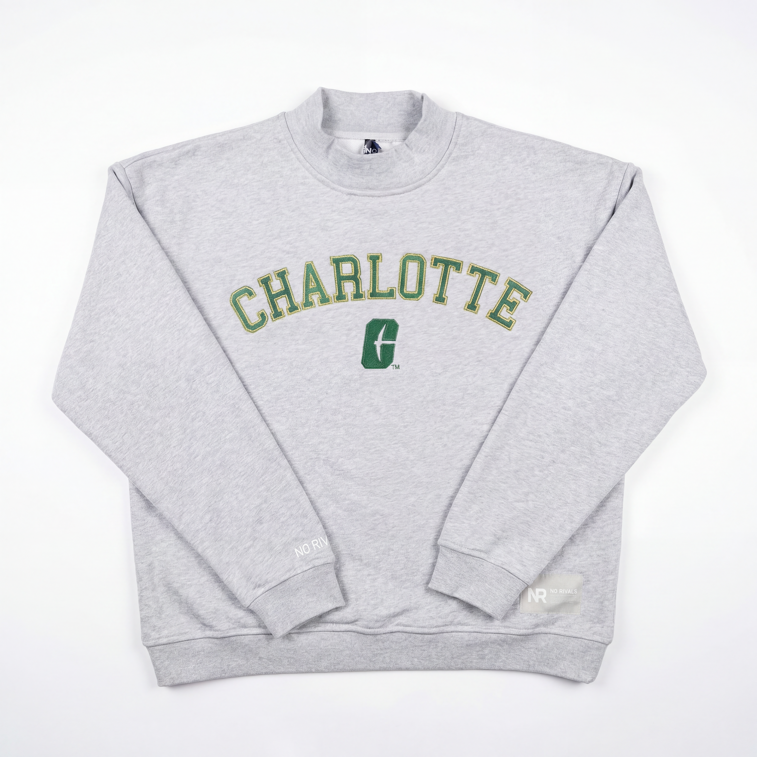The No Rivals UNCC Mock Neck is a light gray, heavyweight cotton crewneck with "CHARLOTTE" in bold green and yellow letters across the chest, a green logo underneath, and an oversized fit, shown on a white background.