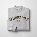 The Vanderbilt Mock Neck by No Rivals is an oversized, heavyweight light gray sweatshirt with VANDERBILT and a large black and gold V embroidered on the front, plus NO RIVALS on the sleeve. Displayed on a plain white background.