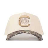 Beige cap with a logo on the front and camouflage bill on a white background