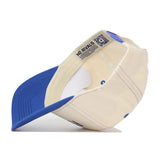 The Florida Vintage Hat is a cream and blue baseball cap seen from underneath, featuring a curved blue brim, cream-colored cotton fabric, visible stitching, and an inside label reading NO RIVALS.