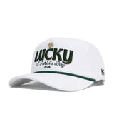 The No Rivals St.Pattys Lucky Cord Hat in white features green and gold "LUCKY" with a shamrock, "St. Patrick’s Day 2026" embroidery, a green-accented brim, unstructured fit, and a small '47 logo on the side.