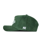 The St.Pattys Lucky Cord Hat by No Rivals is a green, unstructured corduroy cap with white "NR" embroidery and a partial script logo on the front. It features a snap back for easy adjustment and comfortable fit.