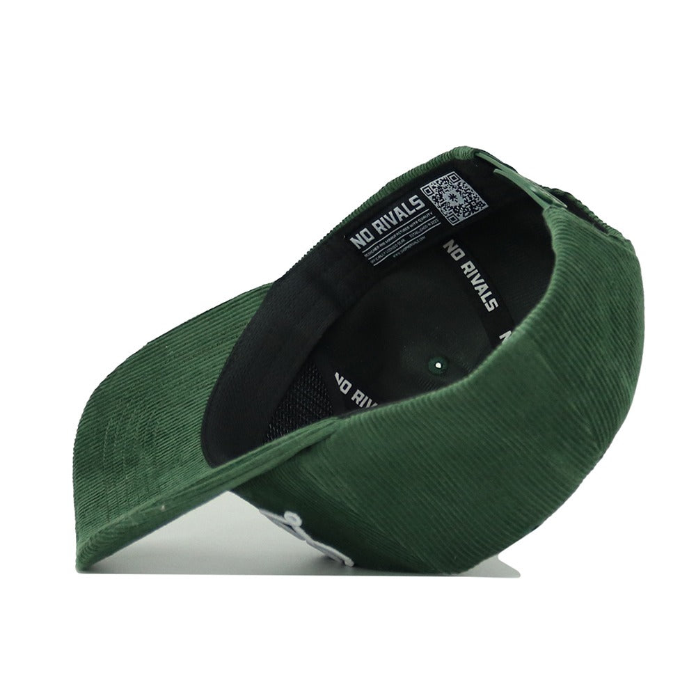 The St.Pattys Lucky Cord Hat by No Rivals is shown from below, revealing a black interior band labeled "NO RIVALS" and a QR code inside the crown. This green corduroy hat features an unstructured fit.