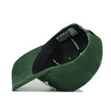 The St.Pattys Lucky Cord Hat by No Rivals is shown from below, revealing a black interior band labeled "NO RIVALS" and a QR code inside the crown. This green corduroy hat features an unstructured fit.