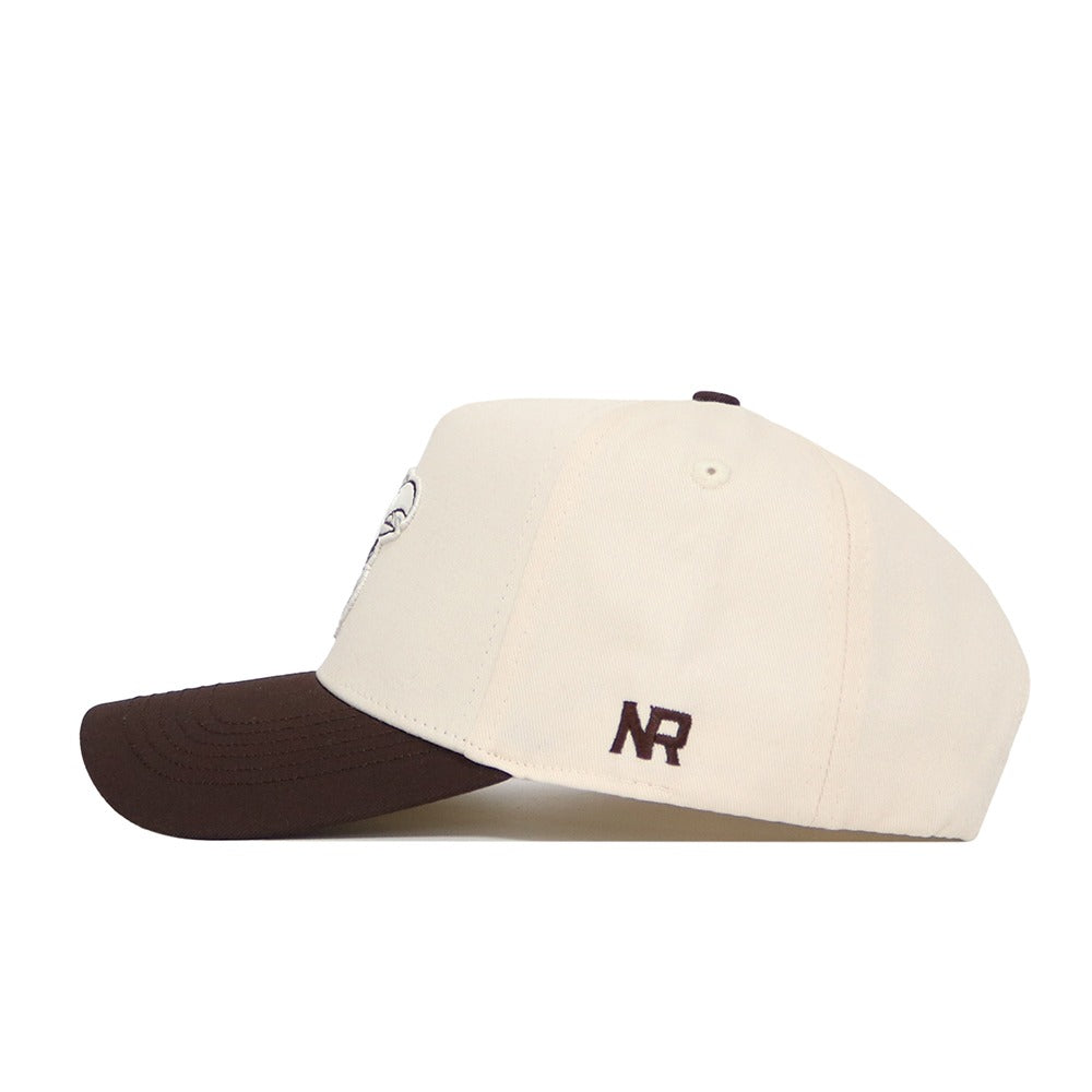 The No Rivals University of Kansas Espresso Hat is a cream snapback with a dark brown curved brim and NR initials embroidered in brown on the side, made from premium cotton. It has a structured fit and is displayed from a side angle on a white background.