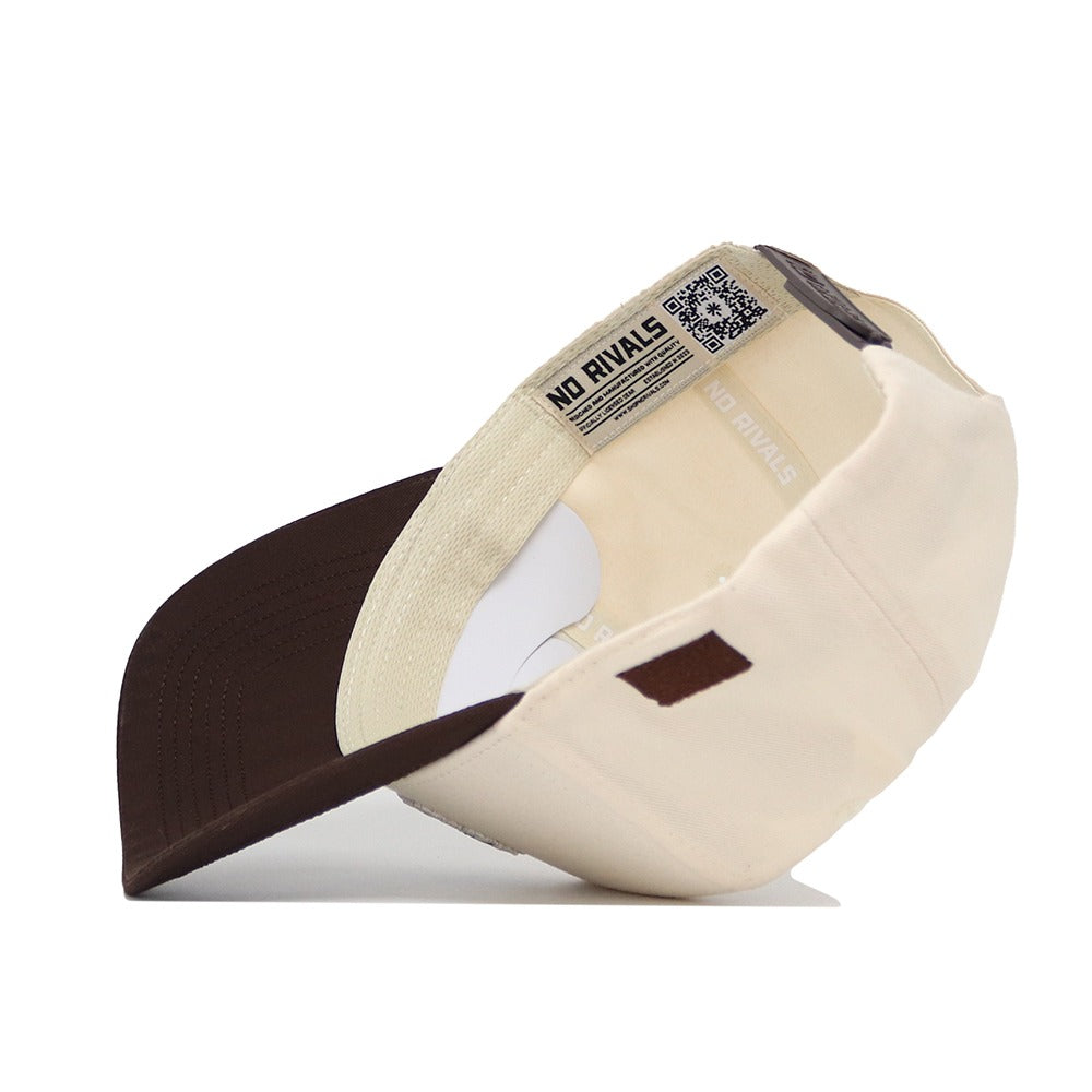 The University of Kansas Espresso Hat by No Rivals is shown upside down, revealing the interior label with "NO RIVALS" text and a QR code on the inner band. Made from high quality cotton for a comfortable, structured fit.