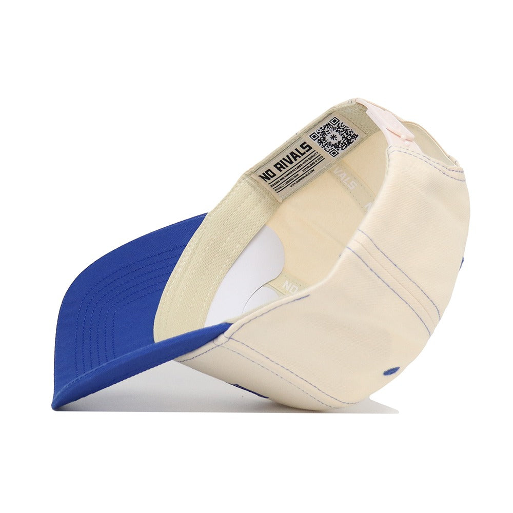 The University of Kansas Vintage Hat by No Rivals is a beige and blue cotton baseball cap featuring an inner NO RIVALS label, a QR code on the band, visible stitching, and an adjustable snapback strap.