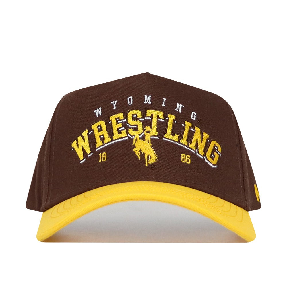 The No Rivals Wyoming Wrestling Hat - Takedown Collection is a brown and yellow cotton dad hat with "Wyoming Wrestling 1886" and a bucking horse logo embroidered on the front.