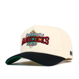 The South Carolina Ballpark Hat by No Rivals is a cream snapback made of quality cotton, featuring "South Carolina GAMECOCKS Est. 1801" embroidered in red, green, and yellow, with a structured fit, black curved brim, and green underside.