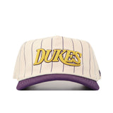 The No Rivals JMU Vintage Wordmark Hat - Pinstripe features beige cotton with thin purple pinstripes, a purple brim, "DUKES" in bold gold embroidery, and an adjustable snap back for comfort.