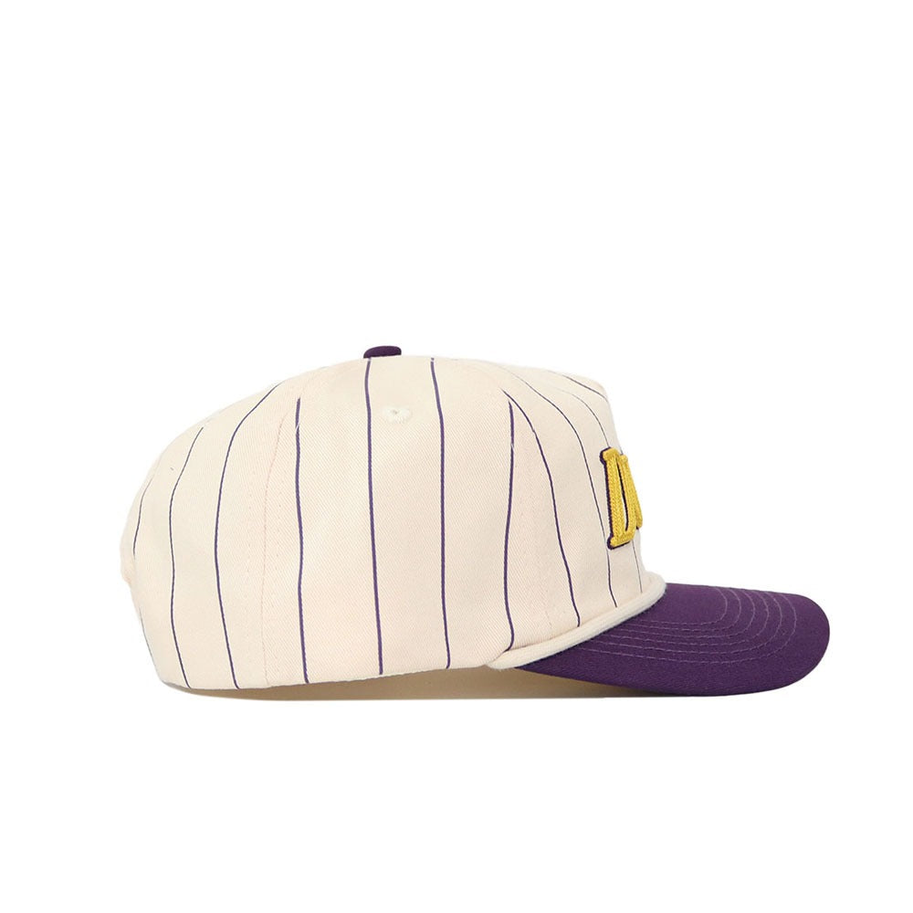 The No Rivals JMU Vintage Wordmark Hat - Pinstripe features a cream base with blue pinstripes, a purple brim, and a yellow embroidered letter on the side. Made of quality cotton with a snapback closure for adjustable fit. Shown in side profile.