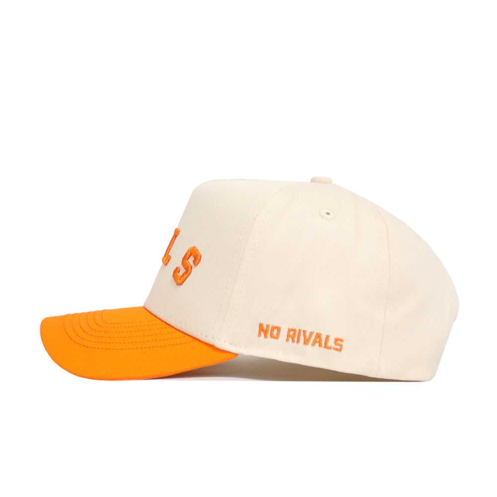 The Right Side Up VOLS Hat by No Rivals features a cream snapback design with an orange brim, made from high-quality cotton. "NO RIVALS" is boldly embroidered in orange on the side of this structured Tennessee Volunteers cap.