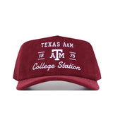 The No Rivals Texas A&M Vintage Cord Hat is maroon with white embroidery of "Texas A&M, 1876, College Station" and the university logo on the front. It has an unstructured fit and a classic snap back closure.