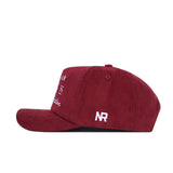 Side view of the maroon Texas A&M Vintage Cord Hat by No Rivals, unstructured fit, with white embroidered "NR" on the side and extra white text on the front, shown against a white background.