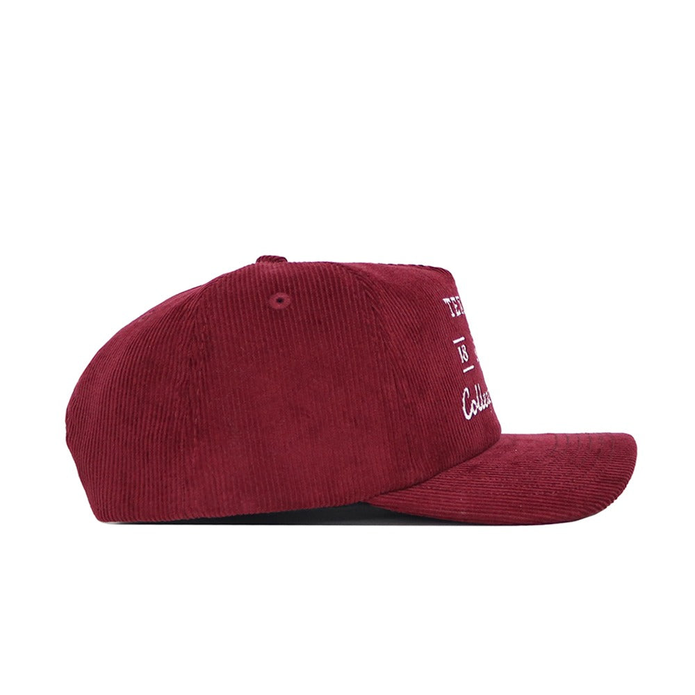 A side view of the No Rivals Texas A&M Vintage Cord Hat in maroon, featuring a flat brim, unstructured fit, and white embroidered text on the front panel.