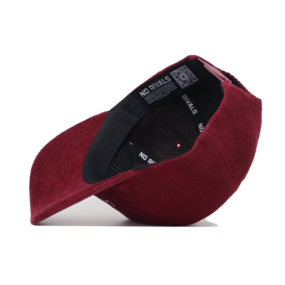 The Texas A&M Vintage Cord Hat by No Rivals features a burgundy corduroy, unstructured fit, a black interior band, and "NO RIVALS" text in white printed on the inner lining.