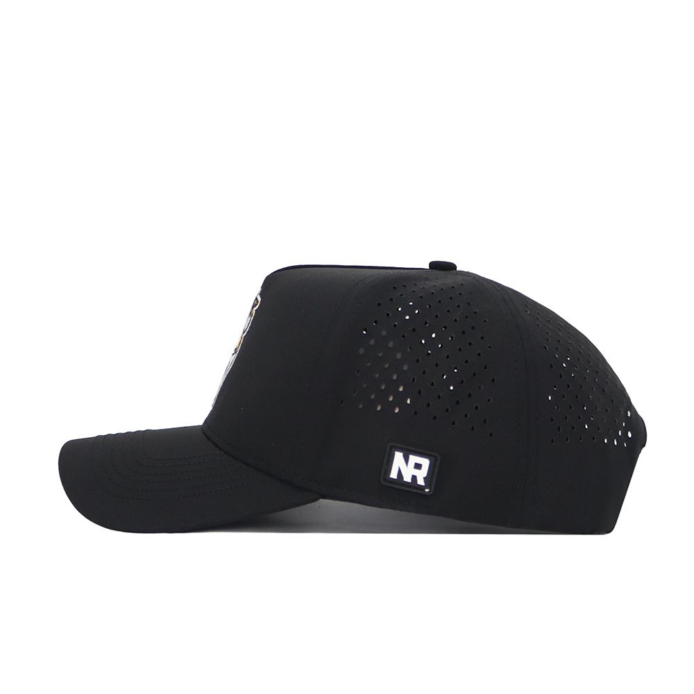 The image shows the No Rivals App State Golf Hat in black, viewed from the left. This polyester-cotton blend snapback features side and back perforations and a small rectangular NR logo patch near the back.