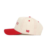 The No Rivals Ball State Vintage Hat is a structured beige and red cotton cap with vibrant red stitching, a red brim, snapback closure, and a small embroidered NR logo on the side.