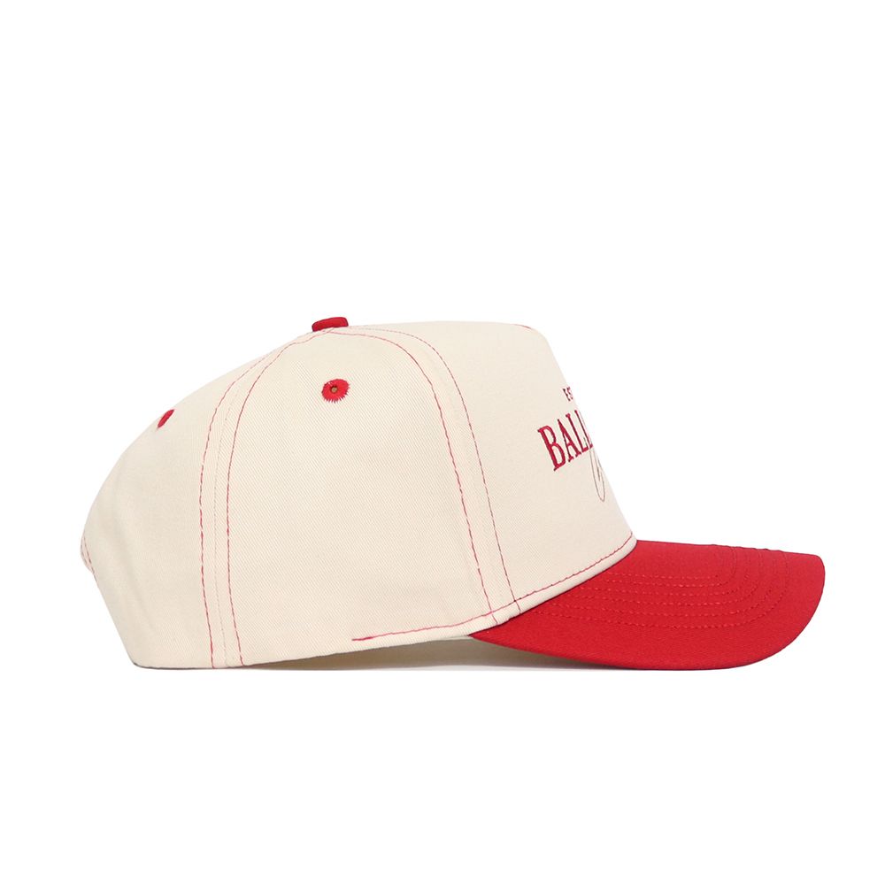 The No Rivals Ball State Vintage Hat is a beige snapback with a red brim and red stitching, shown in side view. Made from high-quality cotton, it features partially visible red text on the front for a structured cap style.