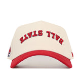 The No Rivals Upside Down Ball State Hat is a cream snapback with a red brim, BALL STATE in red on the front, a cardinal logo on the side, and made from high-quality cotton for a structured fit.