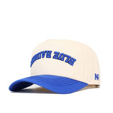 The Upside Down Blue Raiders Hat by No Rivals features a beige crown, blue visor, "BLUE RANGER" embroidered in bold blue on the front, and "NR" initials on the side. Made from premium cotton with an adjustable snapback closure.