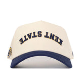 The Upside Down Kent State Hat by No Rivals is a white cotton cap with "KENT STATE" embroidered upside down in navy, a navy brim, yellow and blue logo on the left side, and a structured fit for lasting style.