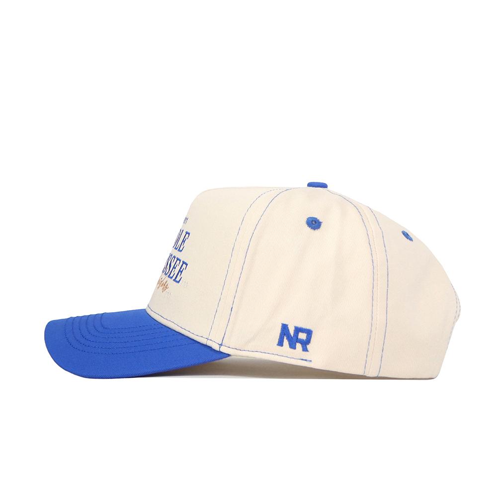 The No Rivals Middle Tennessee Vintage Hat is a cream cotton cap with a blue brim, button, and stitching. "NR" is embroidered in blue on the side. This adjustable baseball cap combines classic style with comfort.